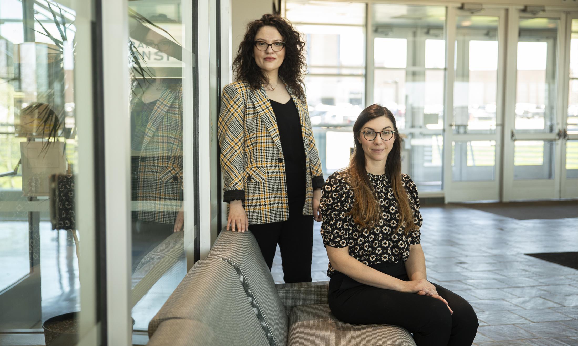 Photo of two female student smiling at the camera