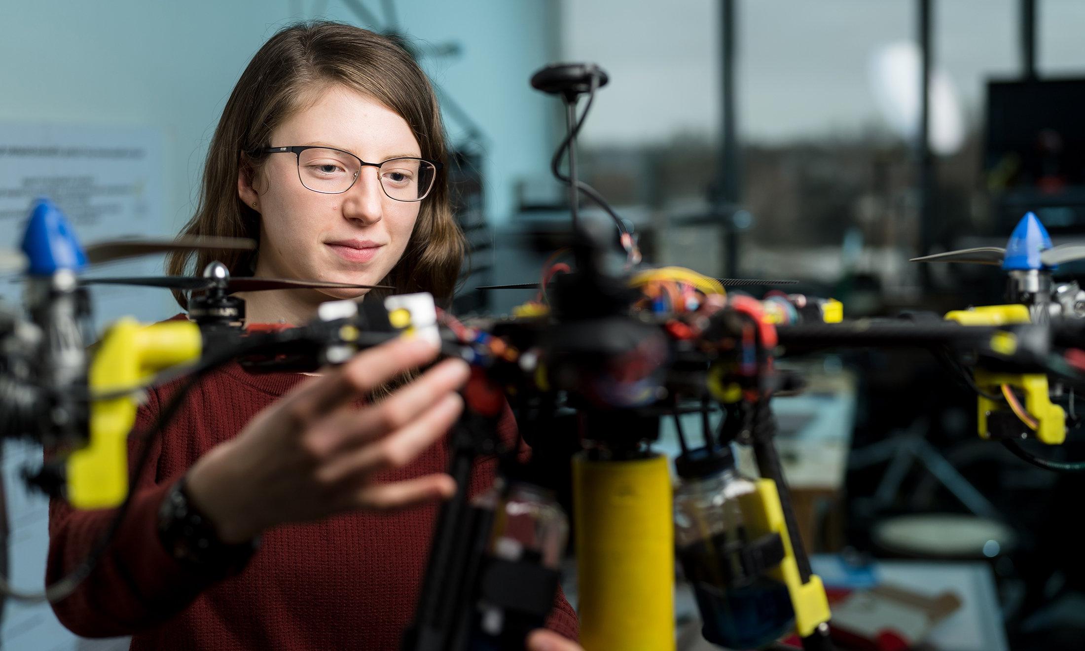 A woman working on a drone.