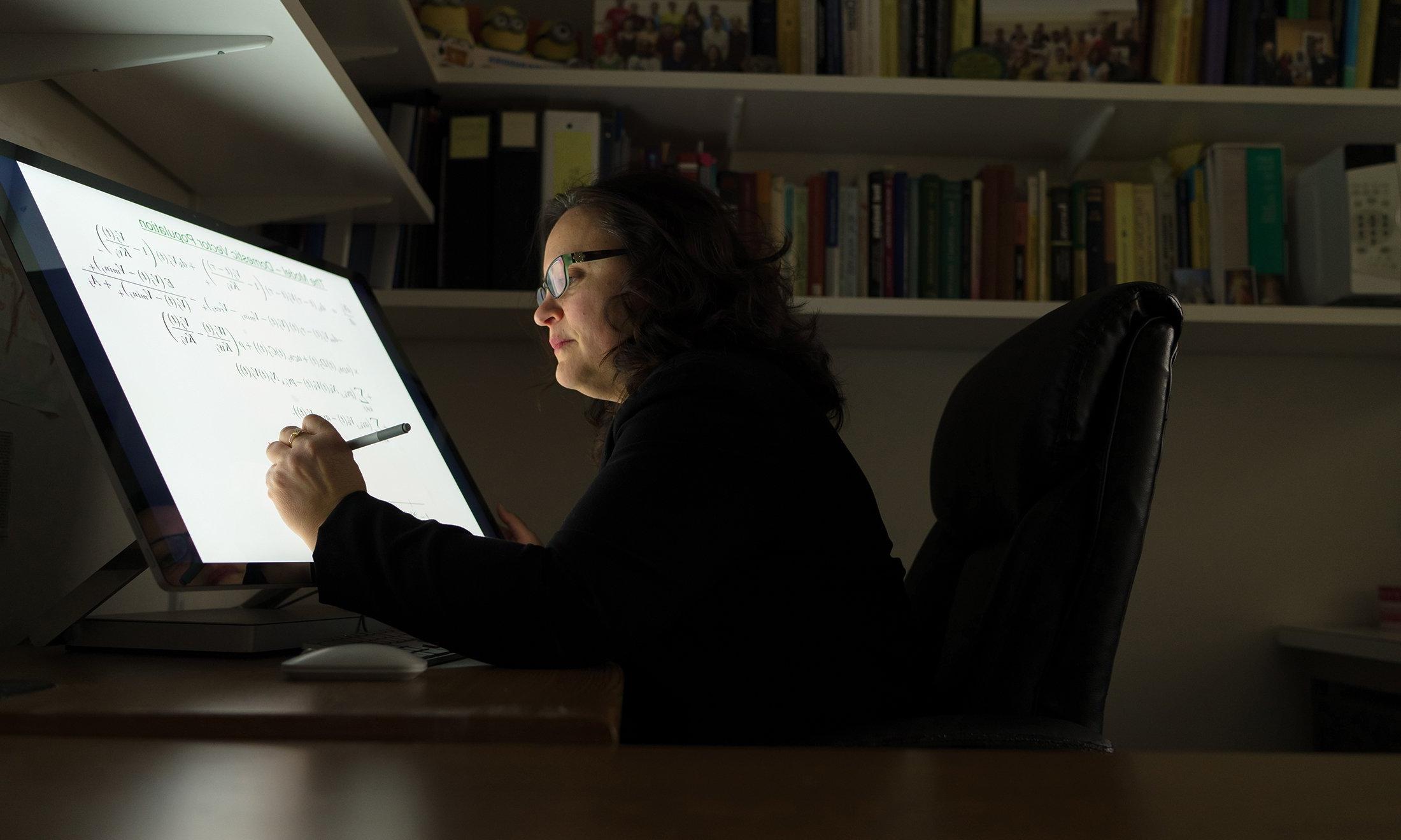 A woman working on her computer.