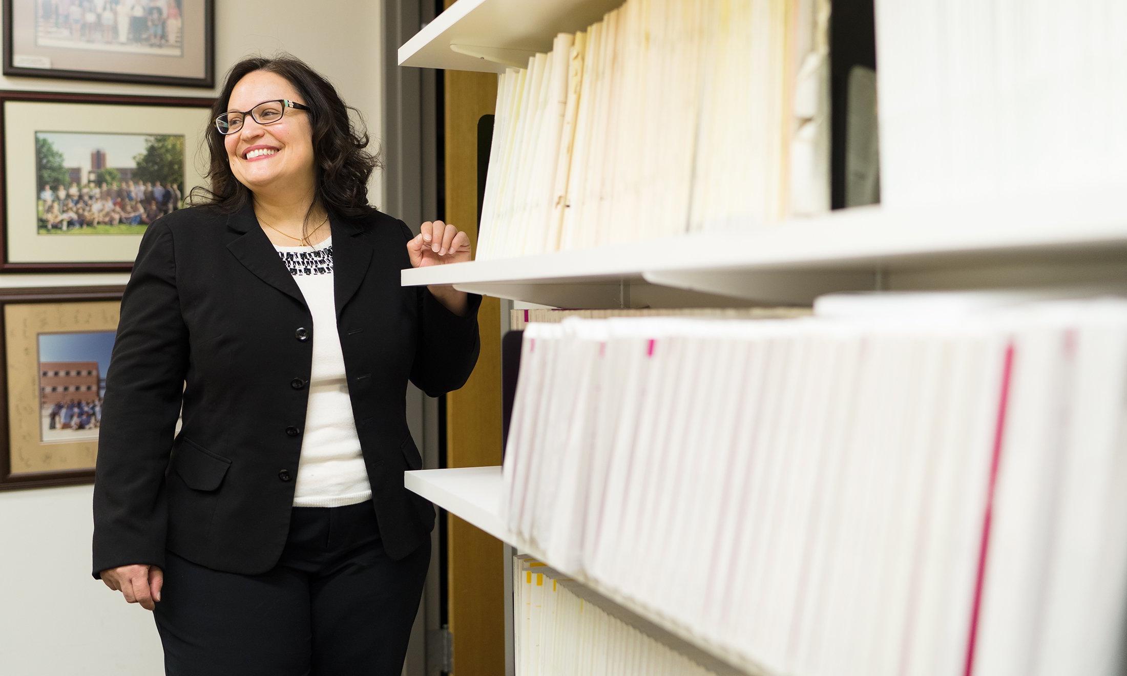 A woman next to shelves.