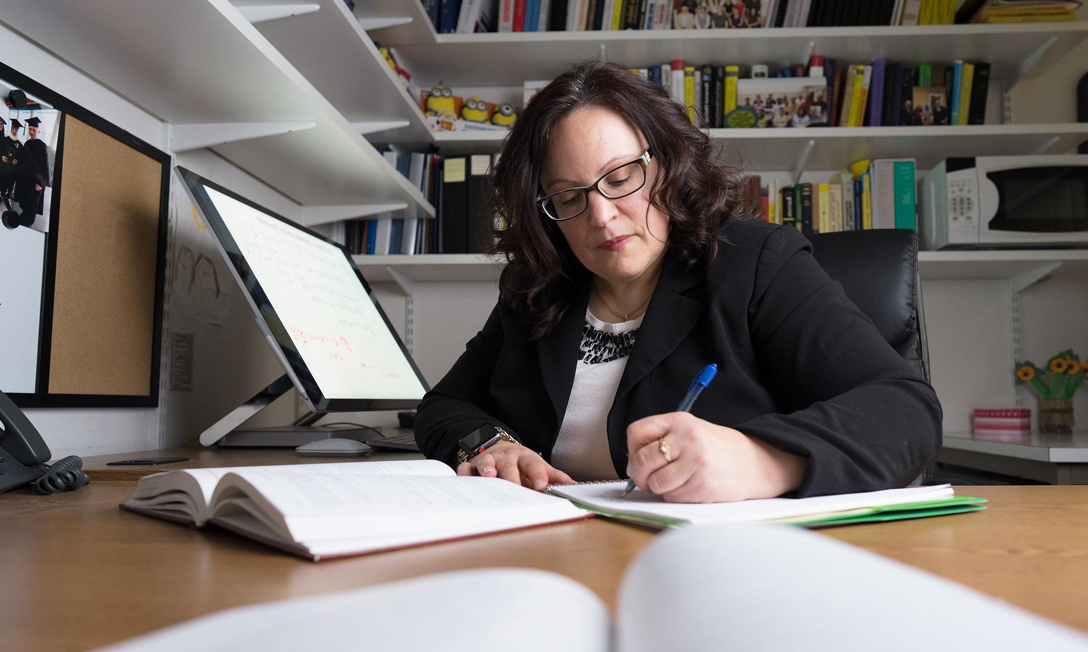 A woman working at her desk.