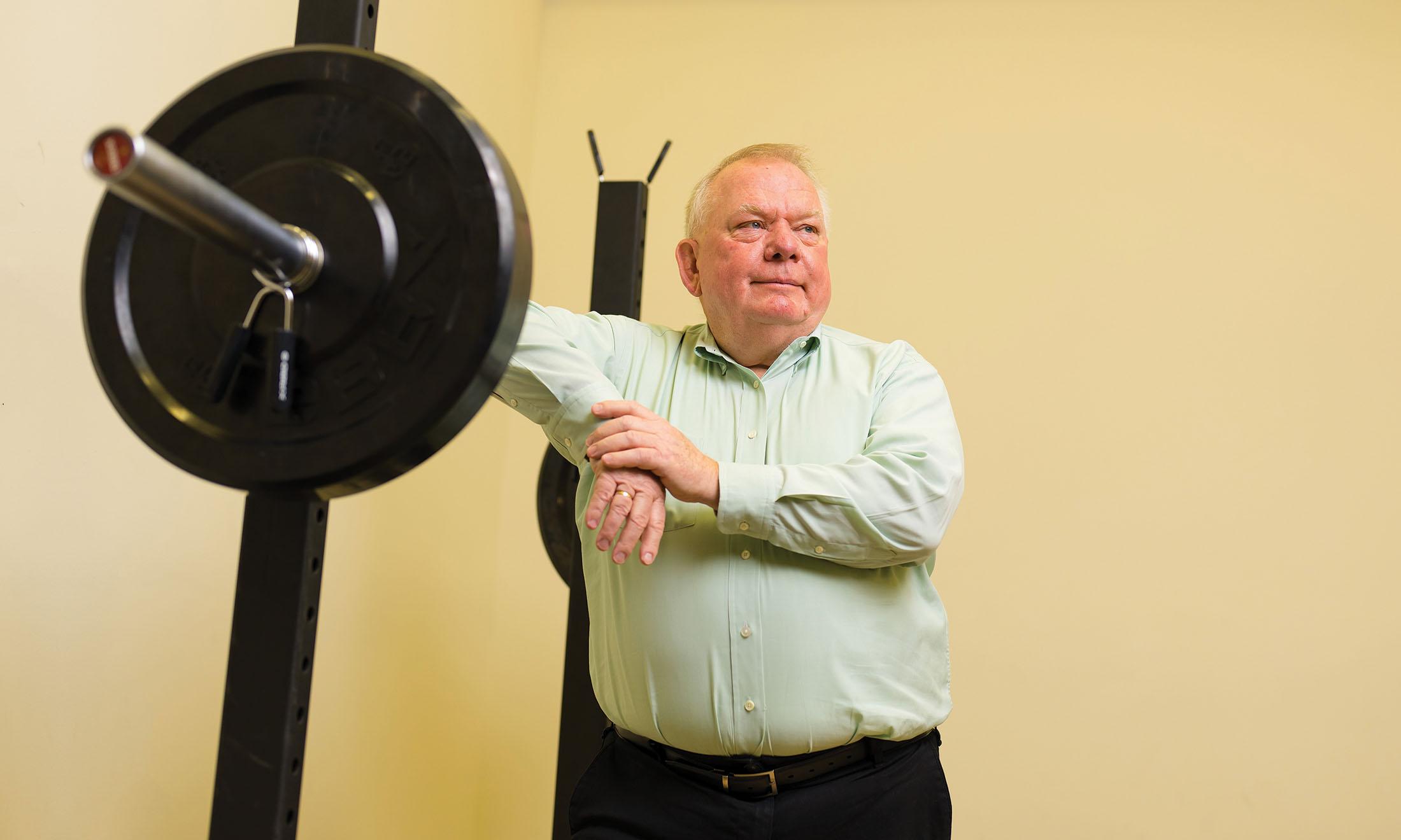 Terry Dibble leaning against weight